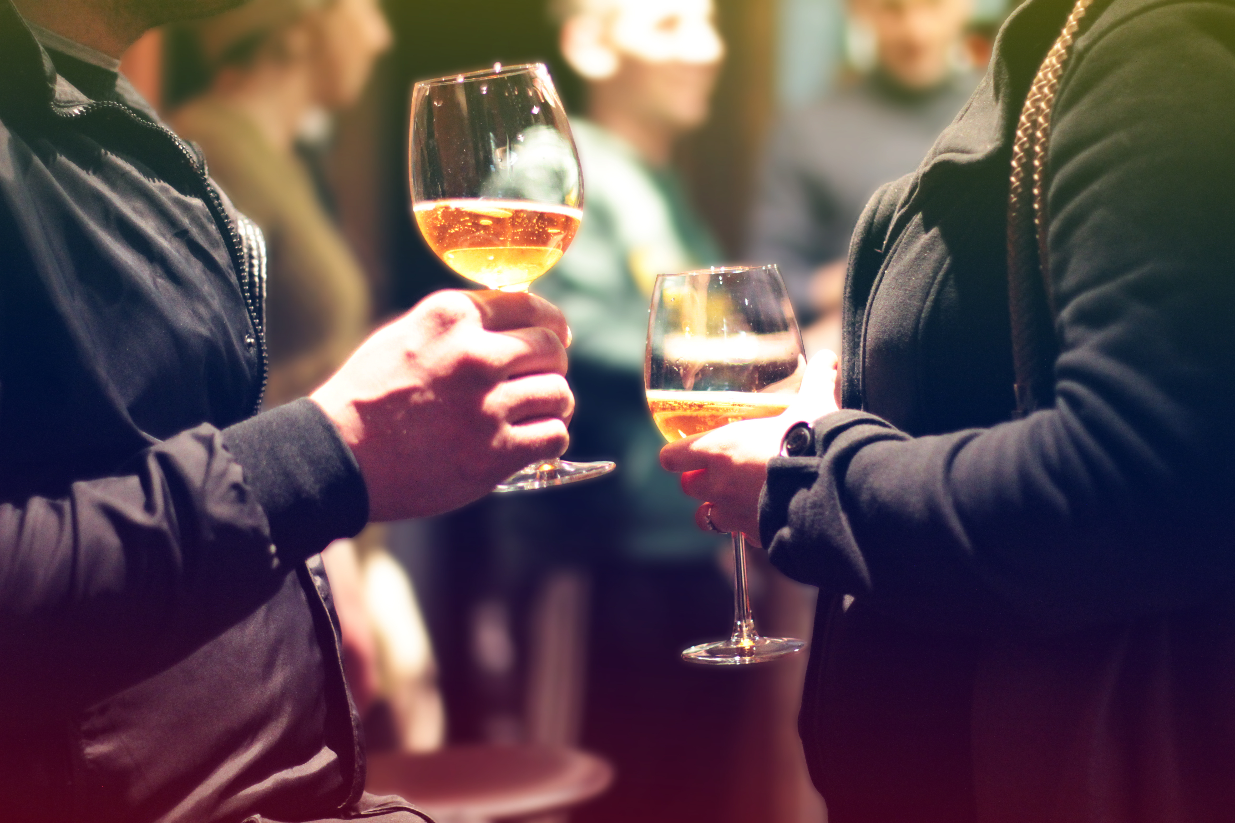 Close up of white wine in glasses in couples