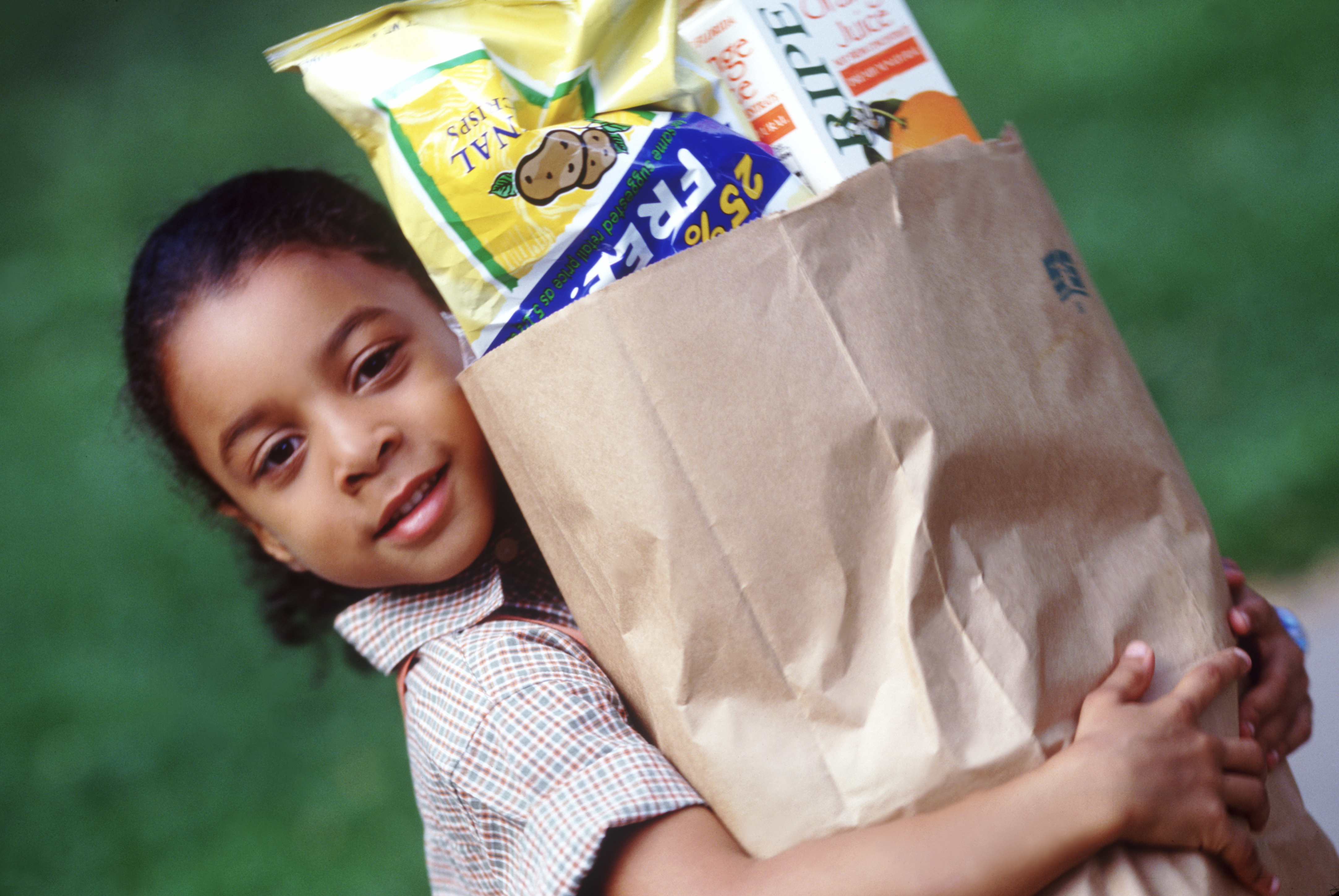 Child carrying groceries