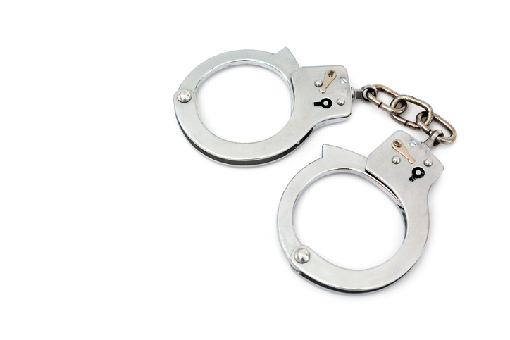 High Angle View Of Handcuffs On White Background