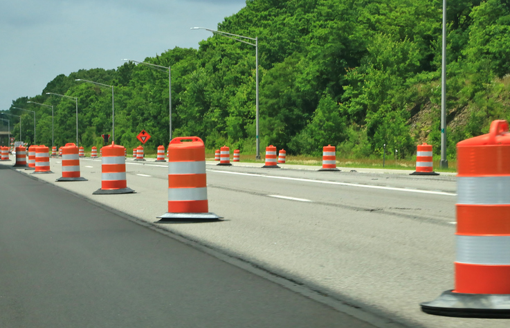 Orange construction barrels along the highway