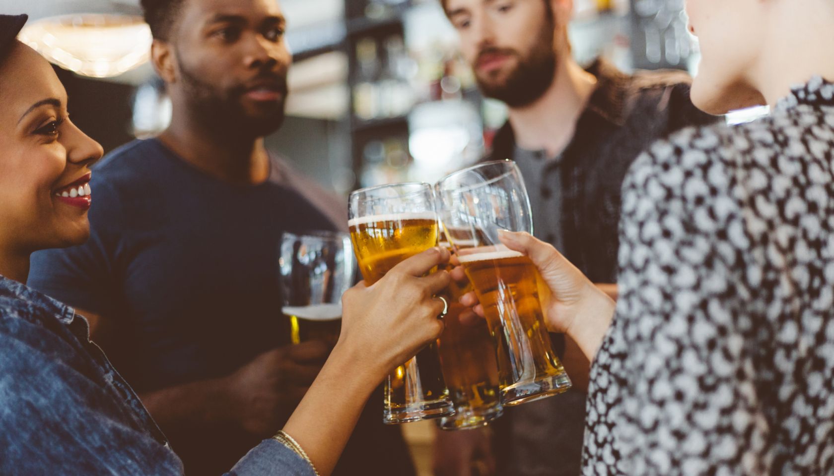 Friends toasting with beer in a pub
