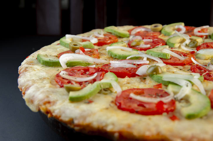 Artisan pizza with meat cheese and fruits