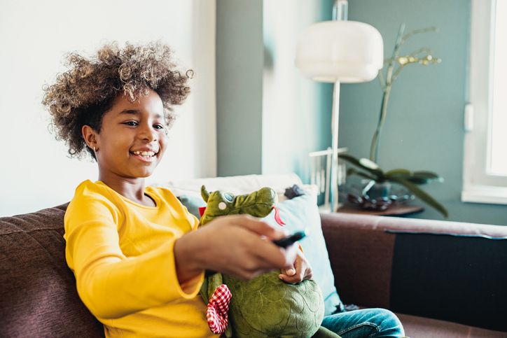 Young girl at home watching TV