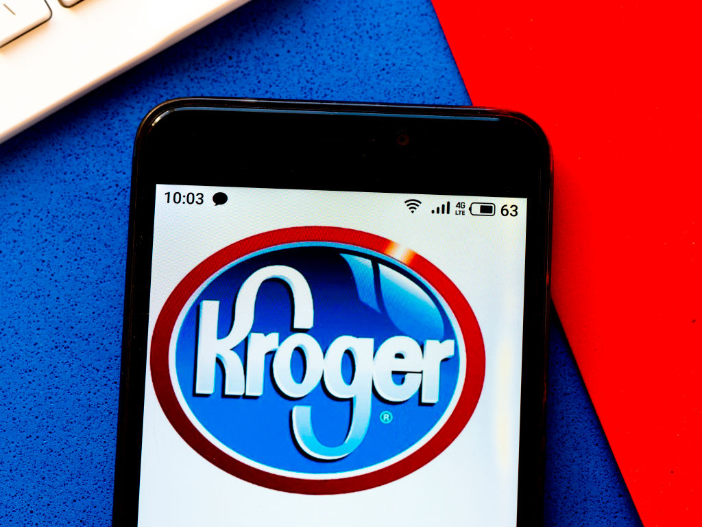In this photo illustration a Kroger logo seen displayed on a...