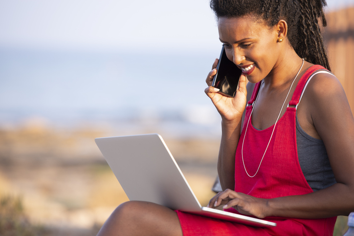 Freelancer woman working online outdoors.