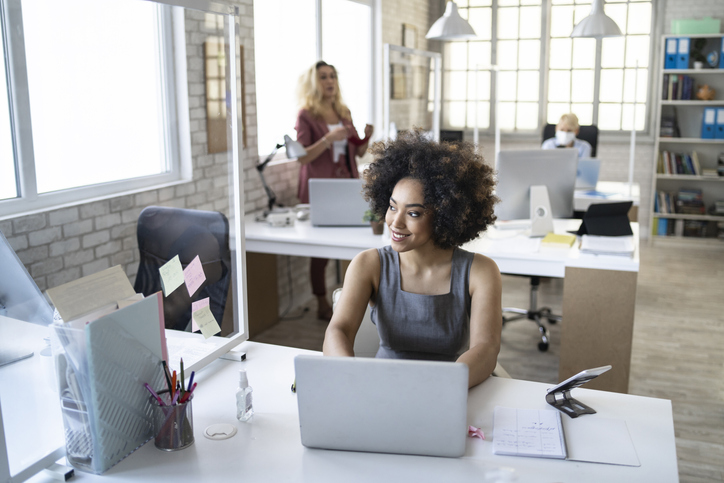 Multi ethnic group of colleagues working in new conditions due to Coronavirus pandemic.