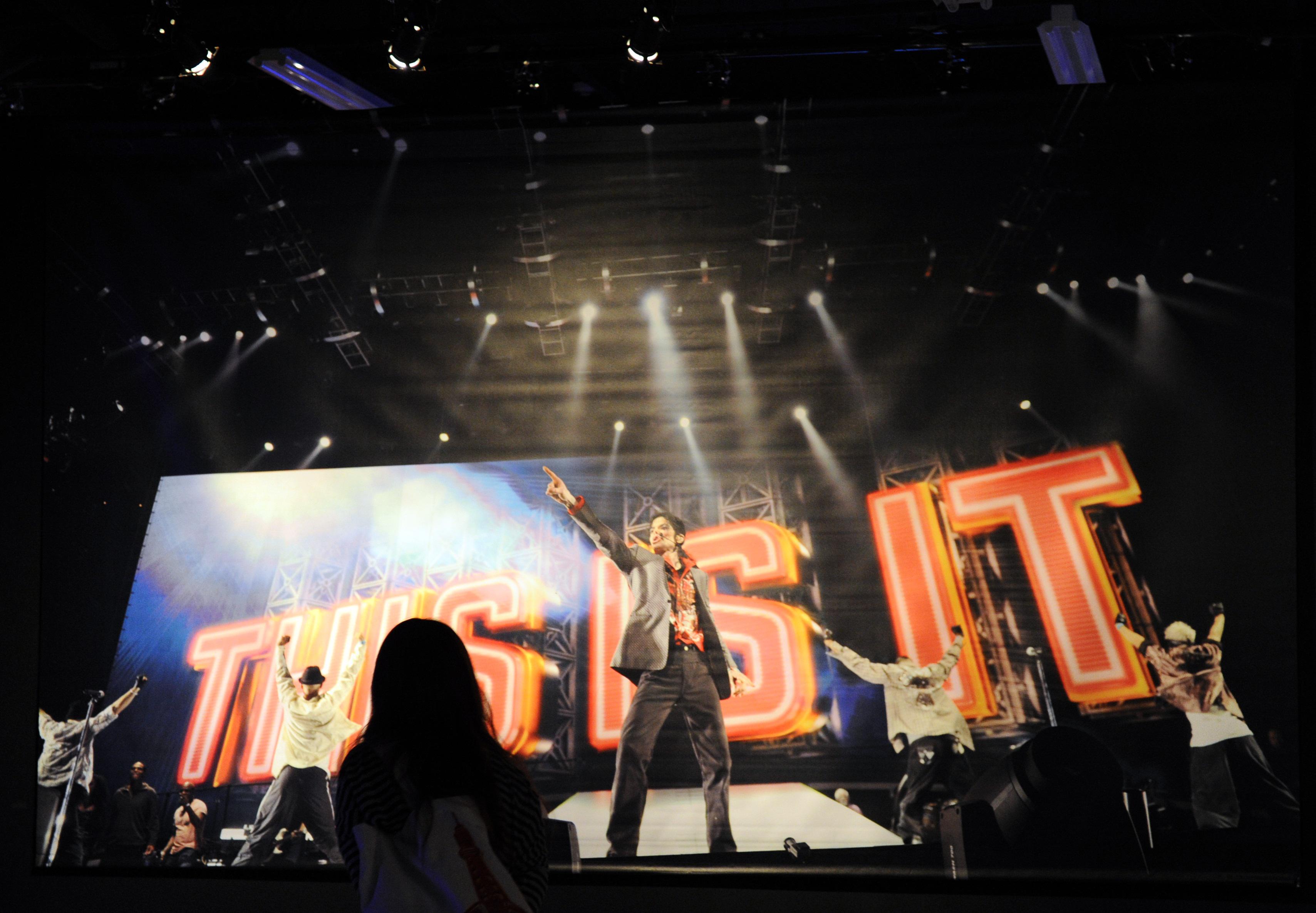 A visitor looks at a picture of Michael