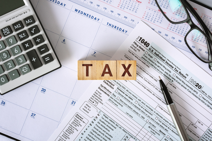 Tax Deadline. Tax Form 1040 on Working Desk.