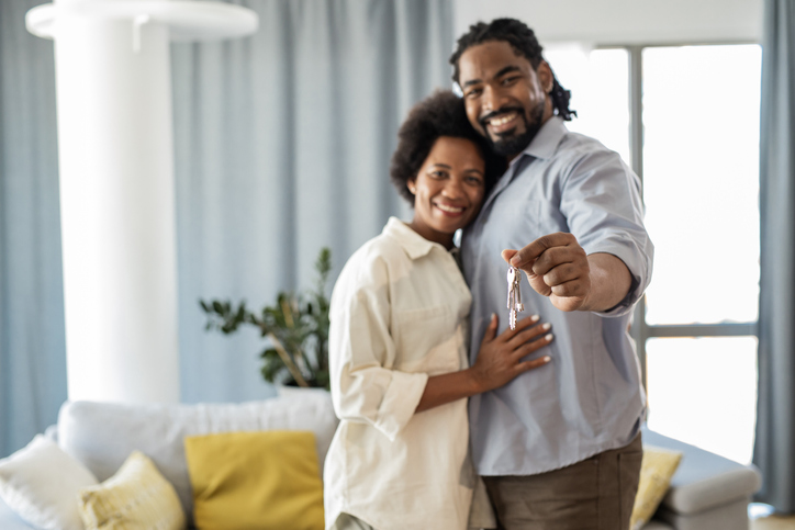 Portrait of couple holding keys of their new home