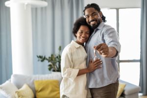 Portrait of couple holding keys of their new home