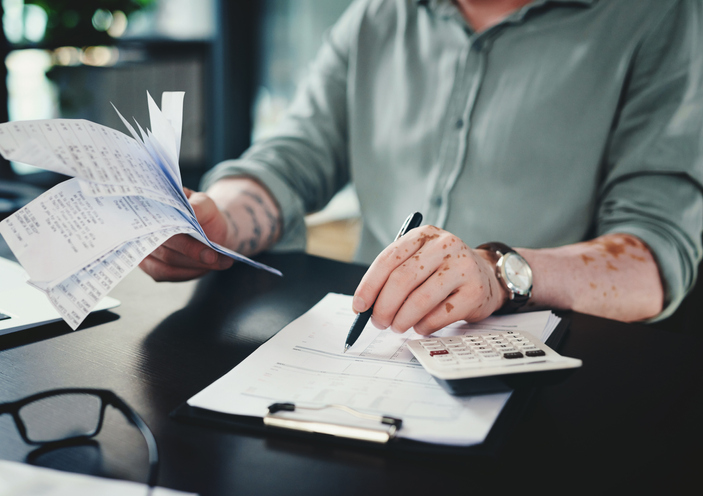 Shot of an unrecognizazble businessman doing paperwork in an office at work