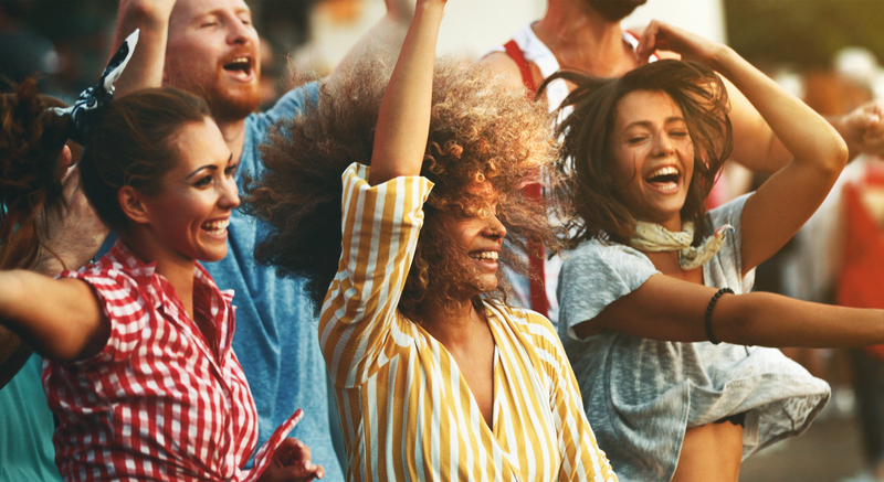 Group of friends dancing at a concert.