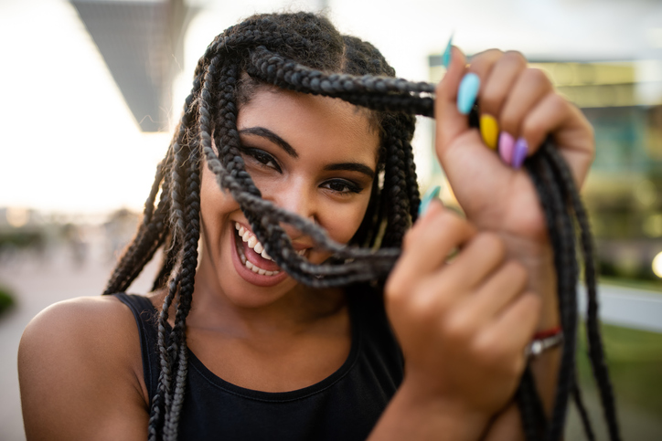 Afro-american teenage model flaunting box braids hairstyle