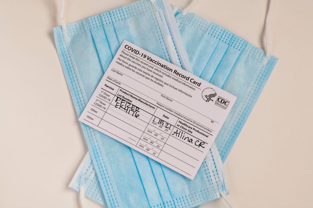 Pfizer Covid-19 vaccination record card with masks, Minnesota.