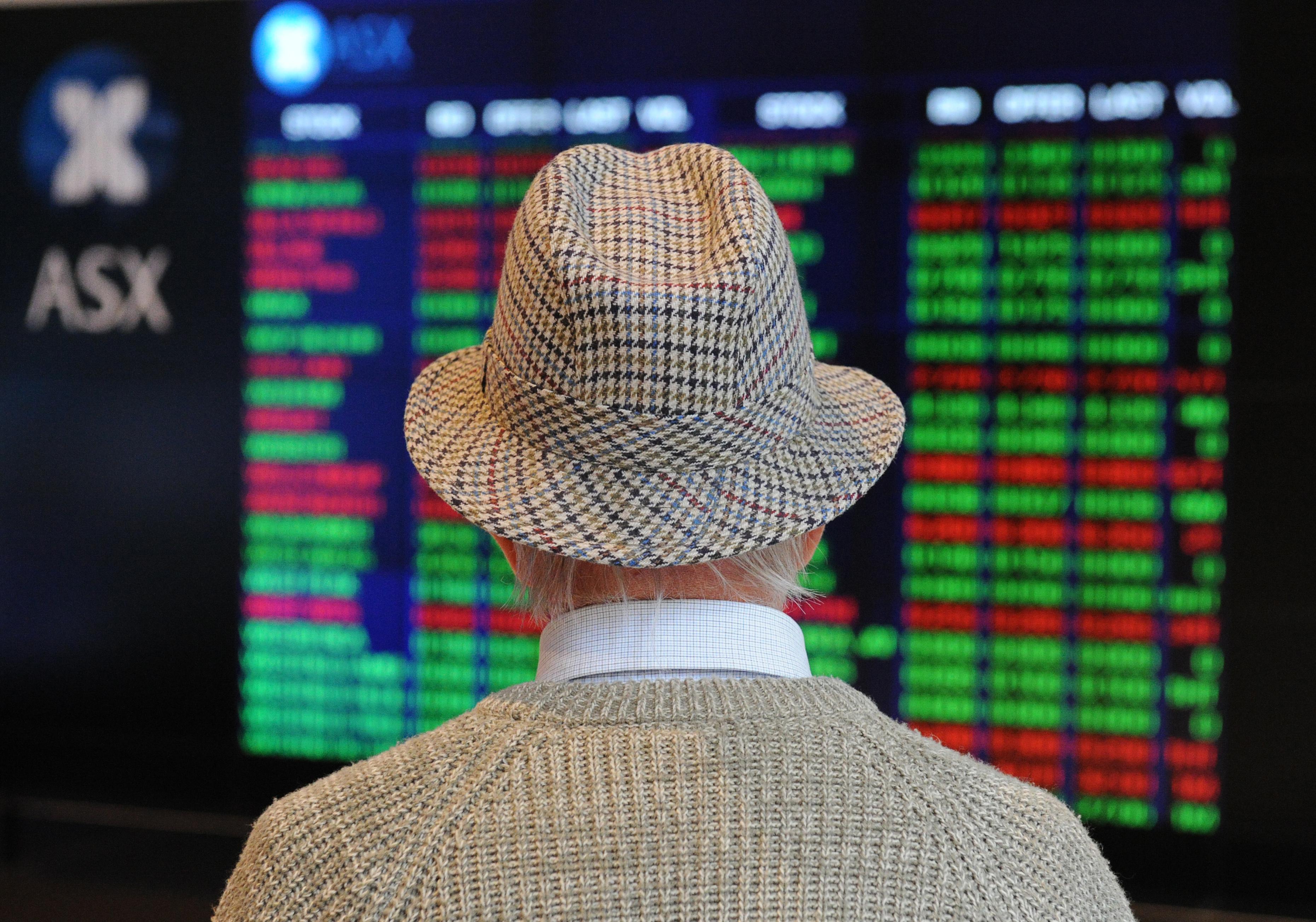 A retiree watches stock prices fall on t