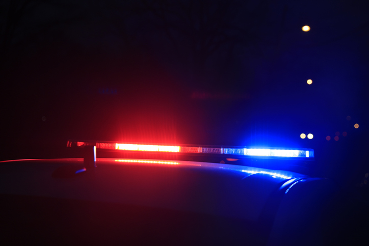 Police vehicles are parked at as police look for a person wanted on an arrest warrant in Bloomington, Indiana.