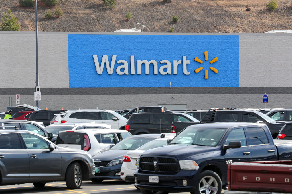 A Walmart logo seen from the parking lot of its store in...