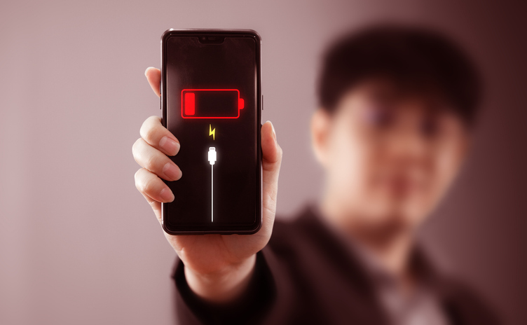 Smartphone's battery power is running low with a virtual low battery symbol warning on the screen.