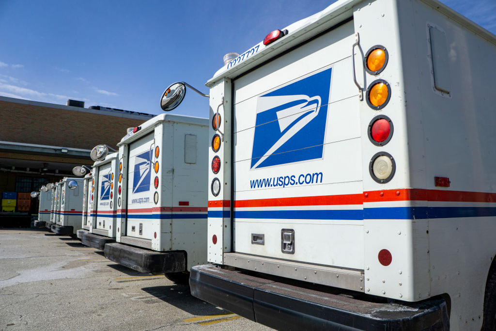 Row of USPS delivery trucks
