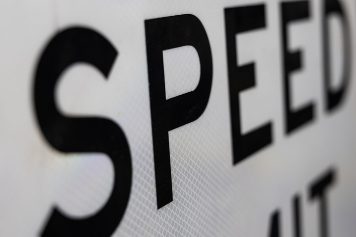 Speed Limit sign close-up with perspective and shallow depth of field. Speed Limit signs are a feature of American highways.