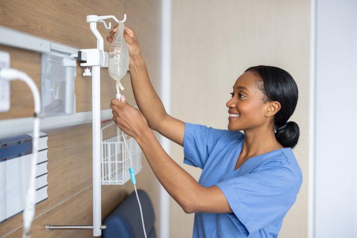 Nurse putting an IV drop at the hospital