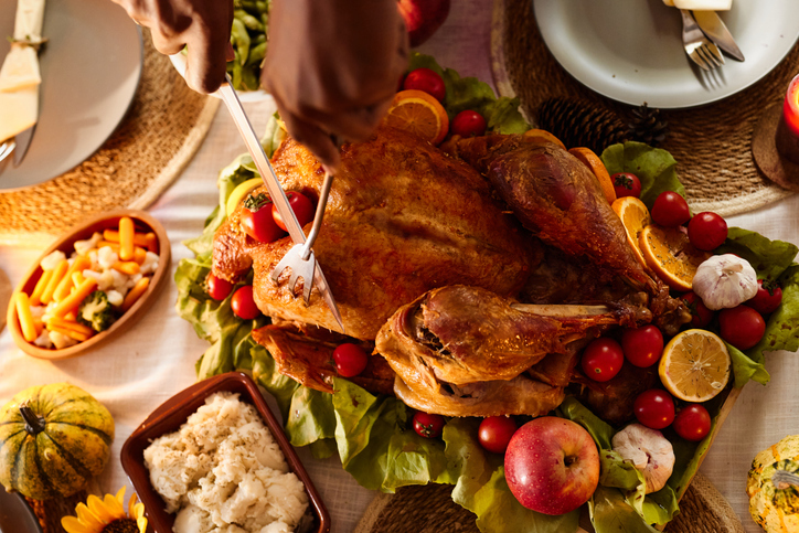 Cutting roasted turkey on Thanksgiving!